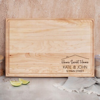 A wooden cutting board with a personalised message on it.