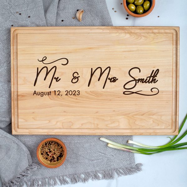 A wooden cutting board with the words mr and mrs smile.