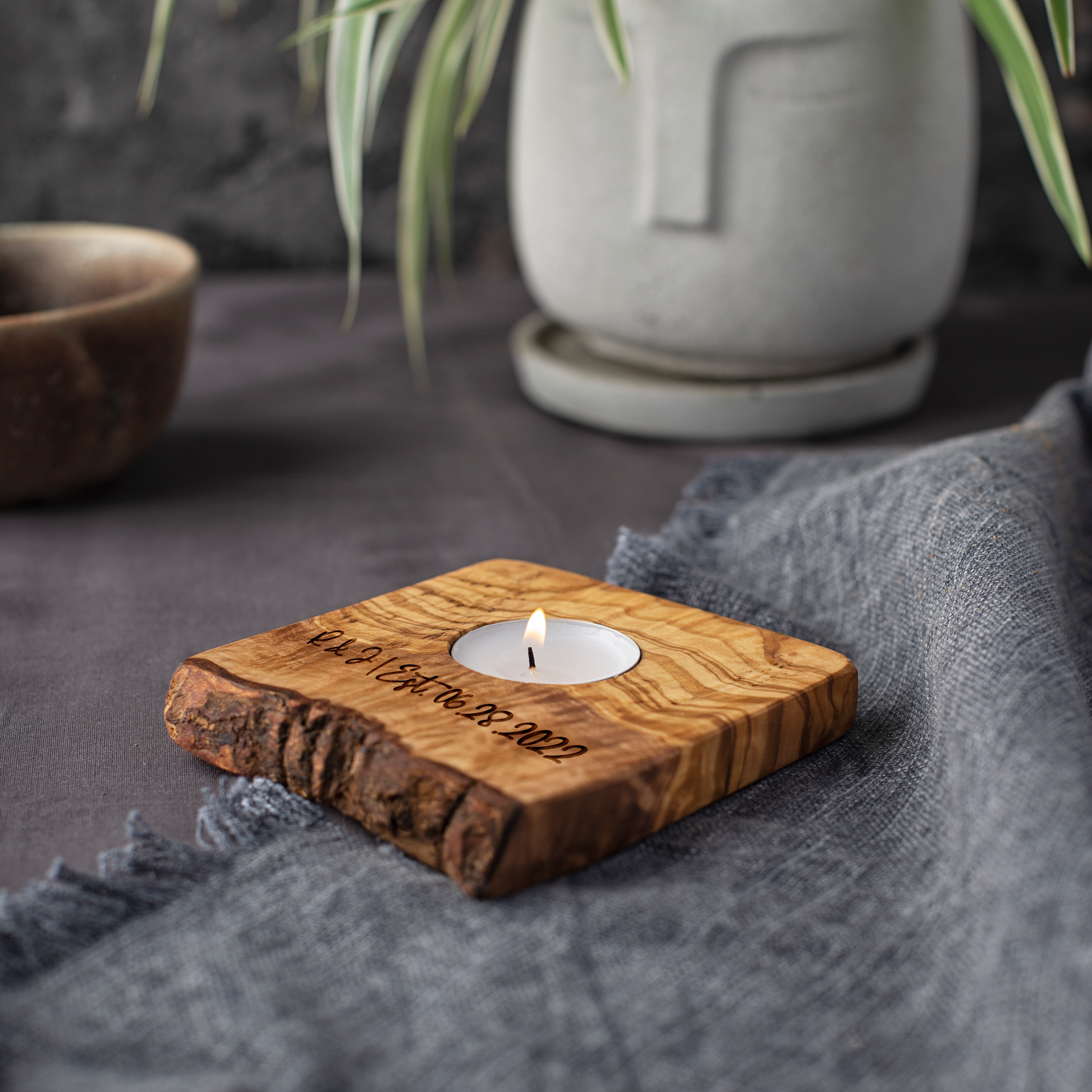 A live edge candle holder with engraved text.