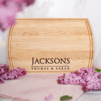 A wooden cutting board with the name jacksons on it.