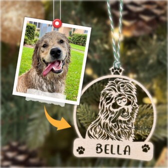 Personalized dog ornament with a photo of a dog hanging on a tree.