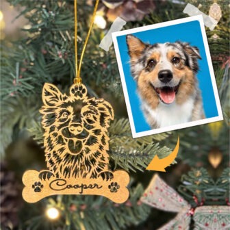 A wooden ornament with a photo of a dog and a bone.