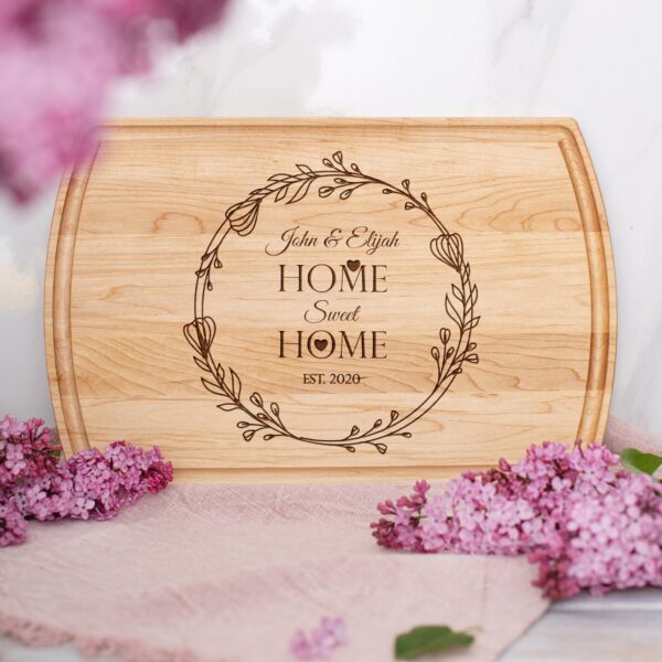 A cutting board with the words home sweet home on it.