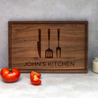 A wooden cutting board with the words john's kitchen.