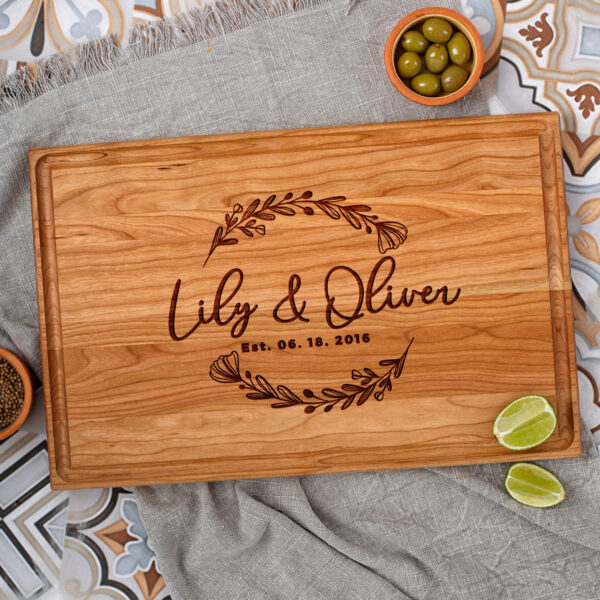 A wooden cutting board with olives and olives on it.