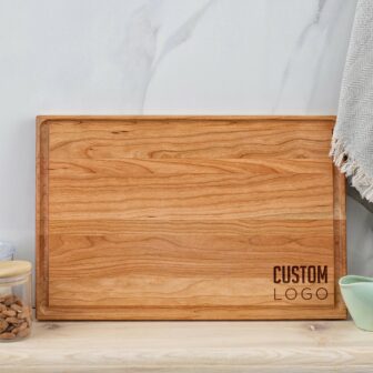 A wooden cutting board with a logo on it.