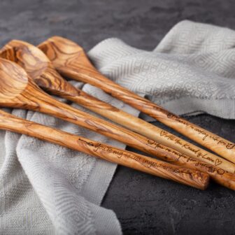 A set of olive wood spoons on a table.