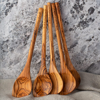 A set of Olive Wood Spoons on a table.