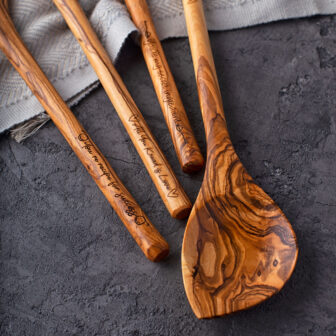Three wooden spoons with a wooden handle.