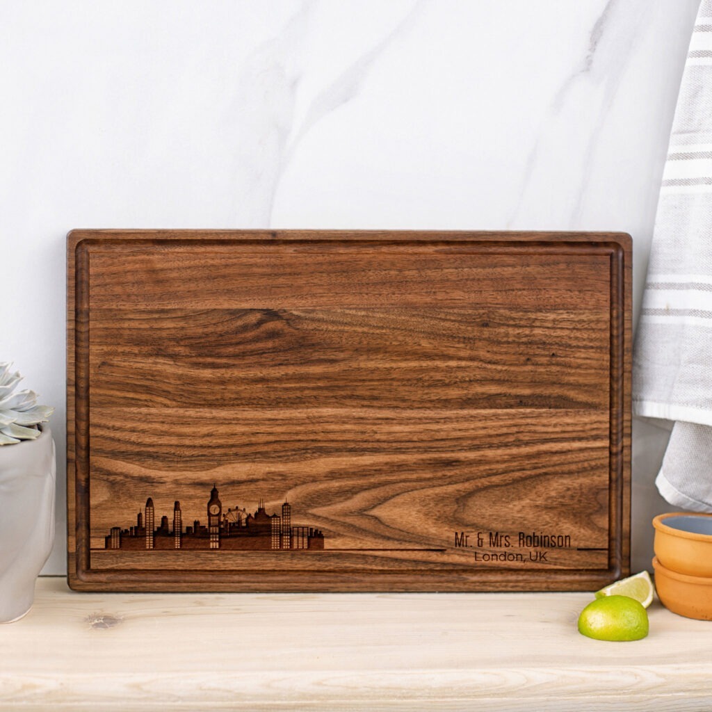 A walnut cutting board with a city skyline on it.