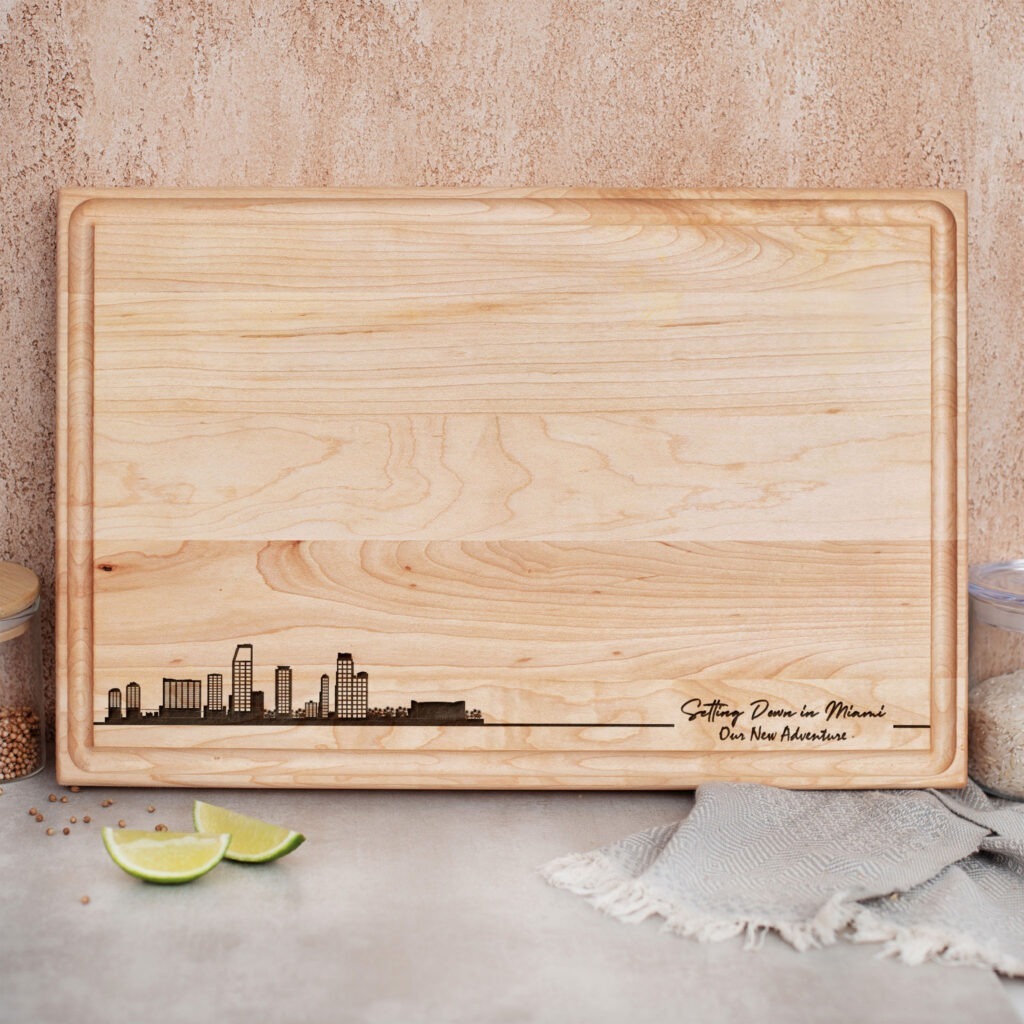 A wooden cutting board with a city skyline on it.