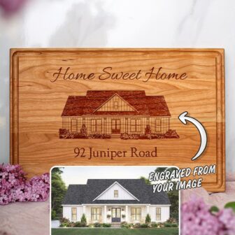 A personalized wooden cutting board with an image of a home sweet home.