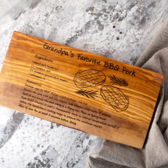 A wooden cutting board with a recipe for a bbq.