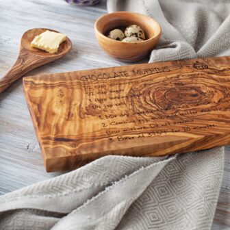 A rectangular wooden cutting board with a recipe written on it.