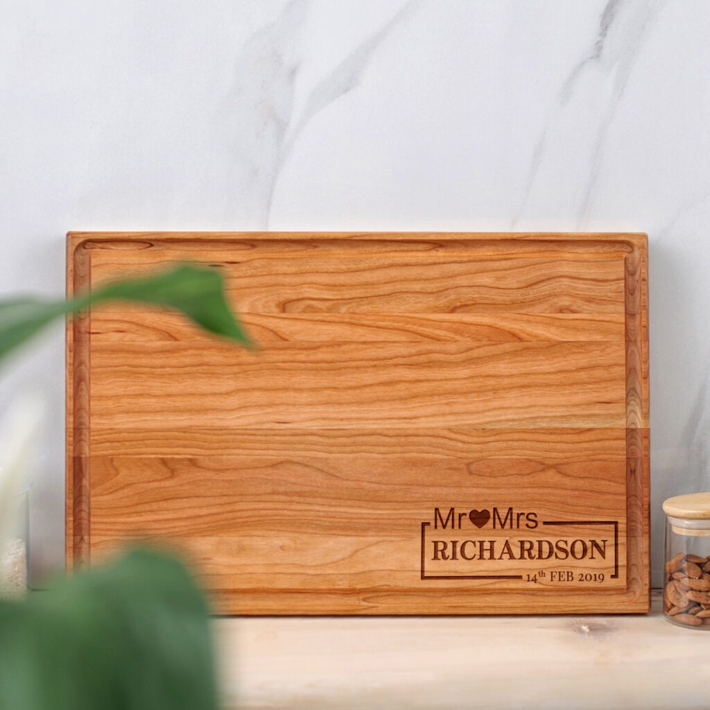 A wooden cutting board with the words mrs and mrs on it.