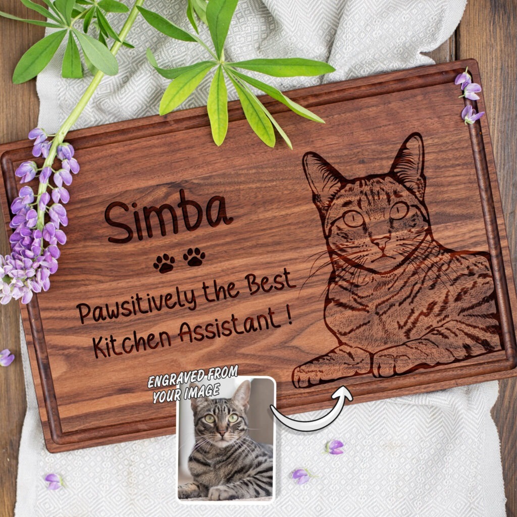 A wooden cutting board with a picture of a cat.