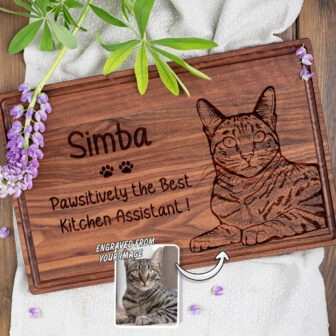 A wooden cutting board with a picture of a cat.