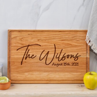 A wooden cutting board with the name the wilson's on it.