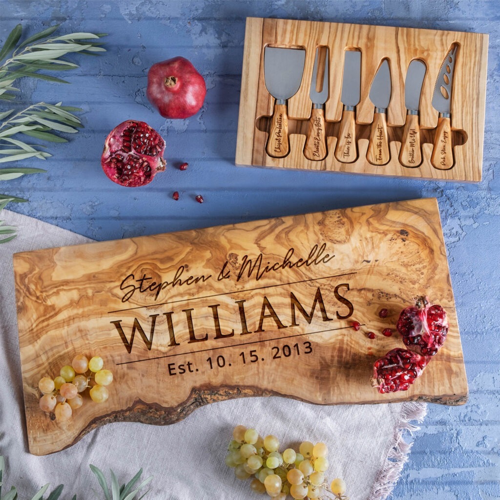 A wooden cutting board with the name williams and grapes.