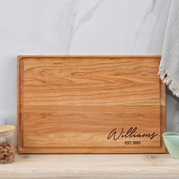 A wooden cutting board with the name williams on it.