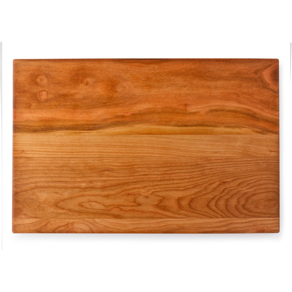 A wood cheese board on a white background.