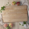 Homemade wood cutting boards with apples and a bag of apples.