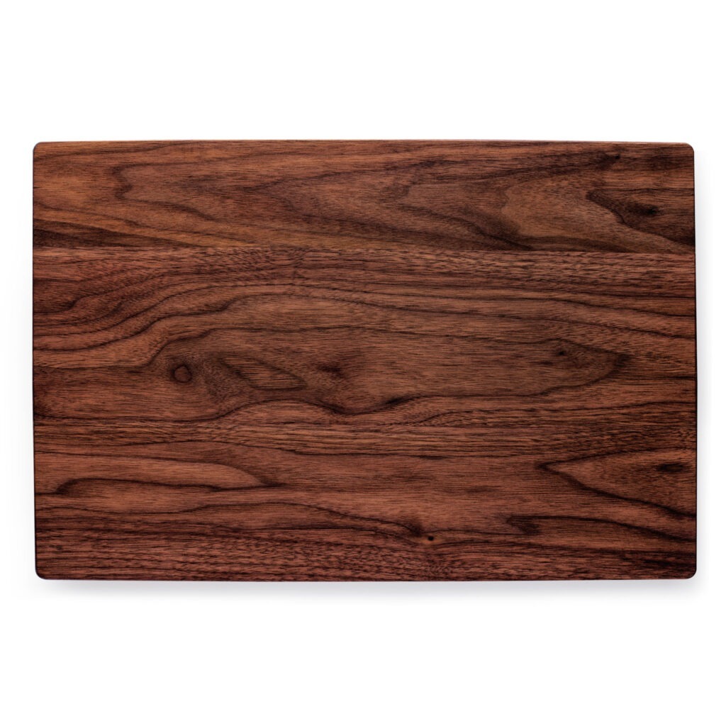 A walnut cutting board on a white background.