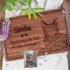Custom engraved wooden cutting board featuring a cat named simba with the title "pawsitively the best kitchen assistant," based on a customer's submitted image of their pet.