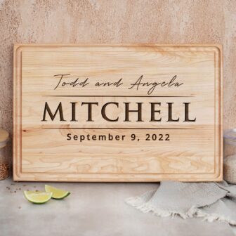 A wooden cutting board with the word mitchell on it.