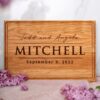 A wooden cutting board with the words'todd and mitchell'.