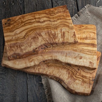Two wooden cutting boards on a wooden table.
