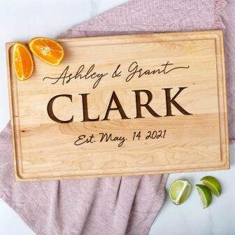 A wooden cutting board with the word clark on it.