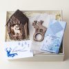 Christmas hostess gift box with a deer tea light holder and napkin rings