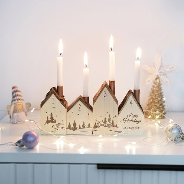 Lit advent candle holder with a company holiday greeting