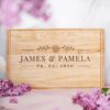 A personalized wedding gift, a wooden cutting board customized with the names.