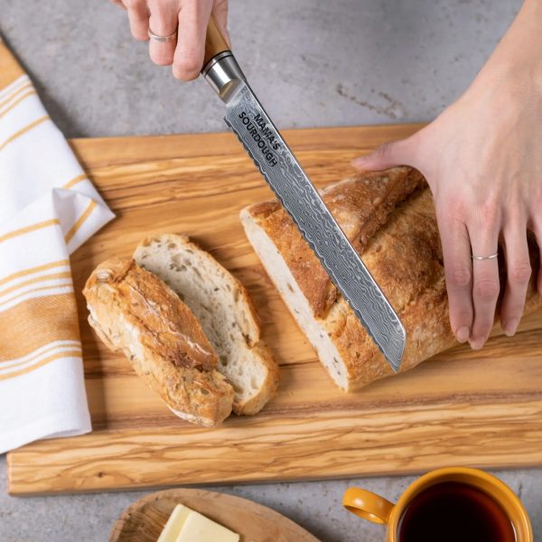 Engraved Damascus bread knife cutting sourdough