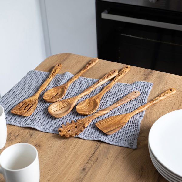 Olive wood spoons and spatulas engraved with a family name on every handle