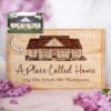 Personalized housewarming gift cutting board engraved from an image of a house.