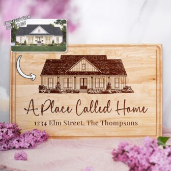 Personalized housewarming gift cutting board engraved from an image of a house.