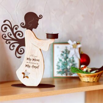 A wooden angel holding a candle on a shelf.