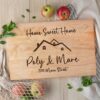 A personalized cutting board with the words "home sweet home" on it, perfect as a realtor closing gift.