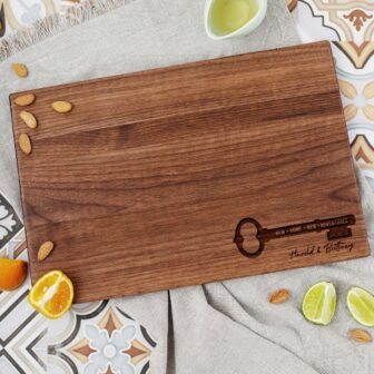A wooden cutting board with oranges and almonds on it.