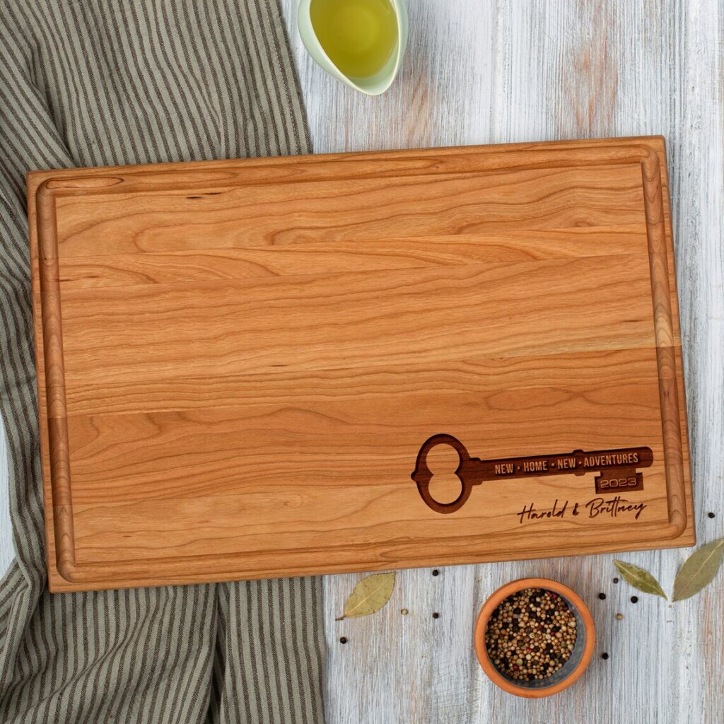 A wooden cutting board with a key on it.