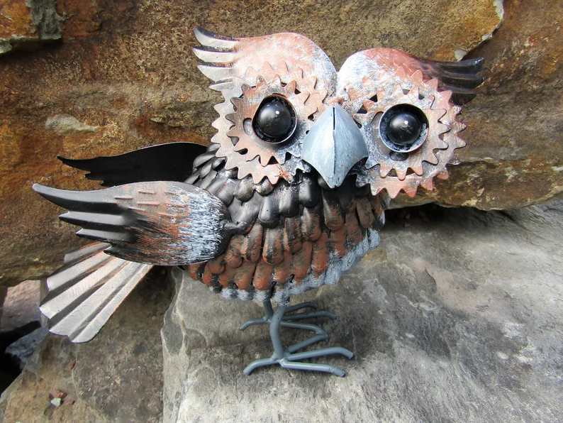 little owl made of metal with 'feathers'