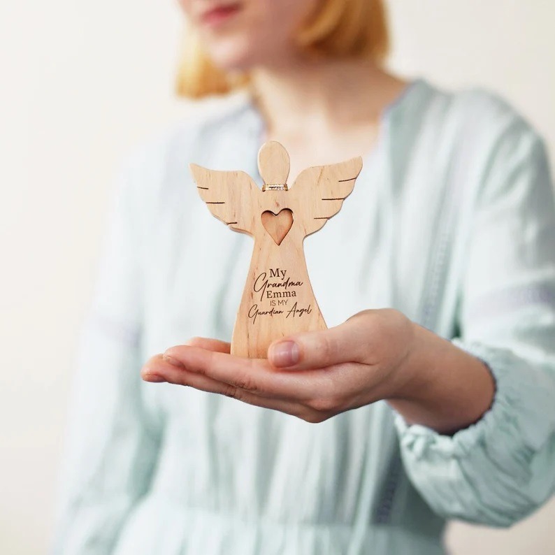 A woman holding a Personalized Guardian Angel Ornament
