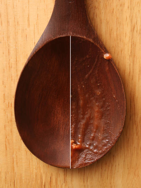 Composition of two shots of a clean and dirty wooden spoon for constrast concept