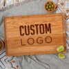A wooden cherry cutting board with the word custom logo on it.