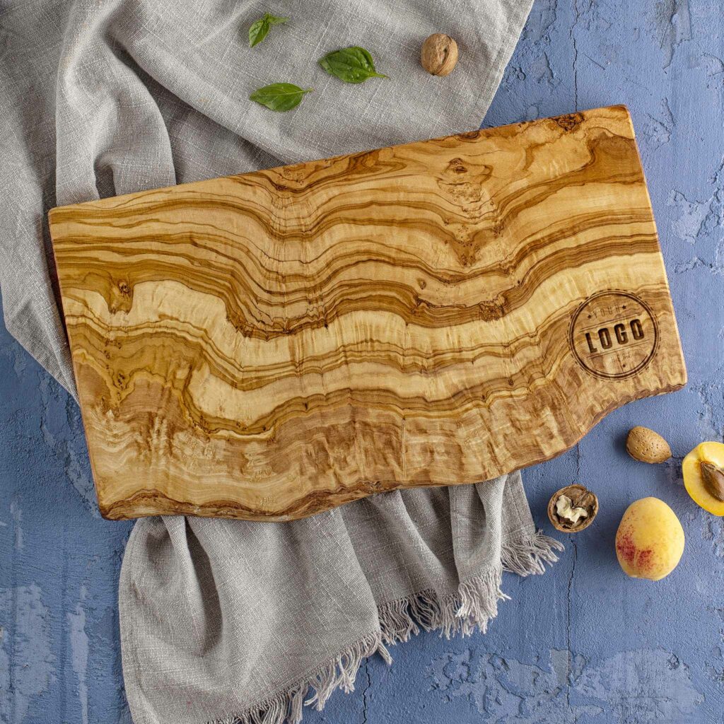 A wooden cutting board with custom logo engraved.