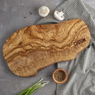 A custom logo cutting board made out of olive wood.