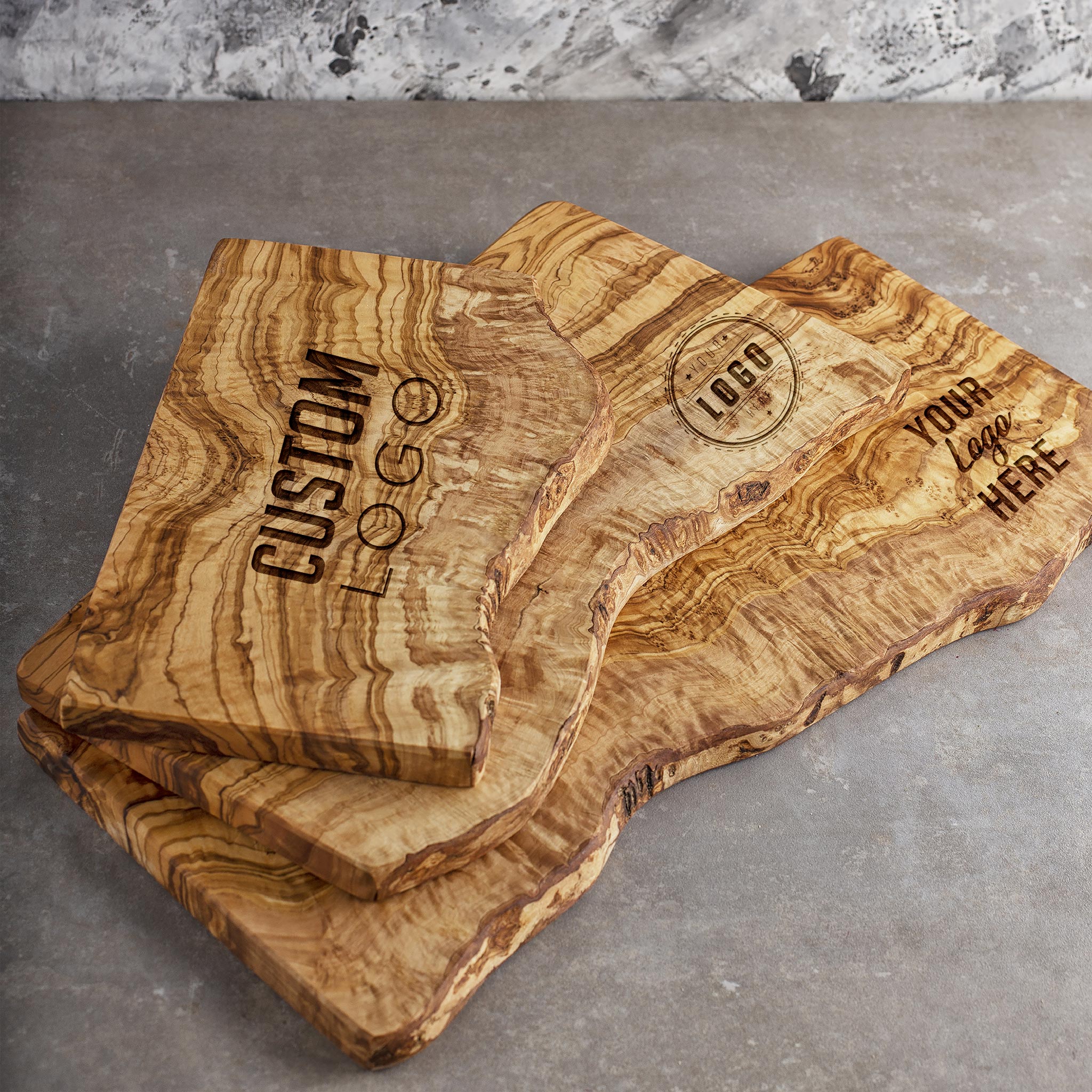 Three olive wood charcuterie boards with custom logo.
